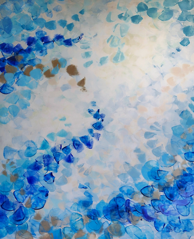 Painting in different shades of blue, beige and white colors hangs on a white wall behind a sofa with white and gray pillows.